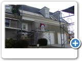 14. 
The new cladding is installed. The new cladding on this house is a cement board stucco system with cultured stone accents. This picture shows the multiple cement coatings and reinforcing mesh that are applied to the attached cement board. 